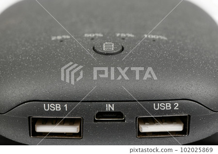 Powerbank new, powerful dark color with two usb inputs on a white background. Side view. Powerbank new, powerful dark color with two usb inputs on a white background. Side view. 102025869