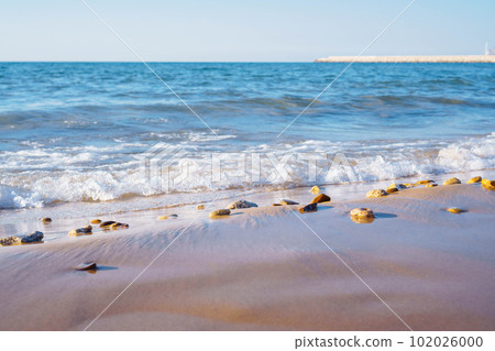 Bright blue sea waves with foam, rolling on coastal sand. Meditation and relaxation. Wonderful moments of life. Rest. 102026000