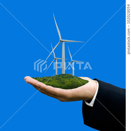 Wind turbine in hand with blue screen background, Sustainable energy concept 102028054