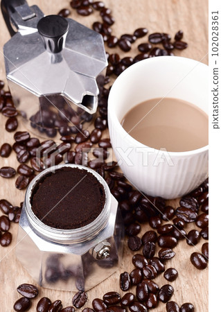 Coffee cup with moka pot and coffee beans, High angle view Coffee cup with moka pot and coffee beans, High angle view 102028361