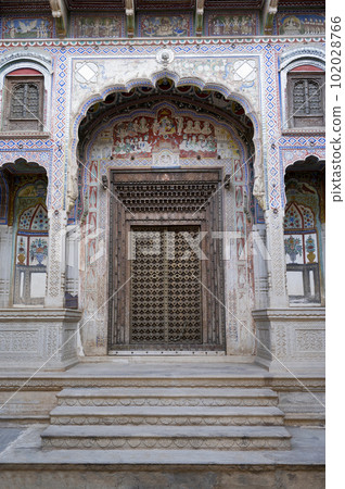 Fresco paintings and carved wooden door of Kamal Morarka Haveli Museum in Shekhawati. Marwari merchants constructed grand havelis in the Shekhawati region dated 17th to 19th centuries richly decorated Fresco paintings and carved wooden door of Kamal Morarka Haveli Museum in Shekhawati. Marwari merchants constructed grand havelis in the Shekhawati region dated 17th to 19th centuries richly decorated 102028766