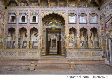 Colourful paintings and carved wooden door of Dr. Ramnath Podar Haveli Museum, a cultural heritage museum which houses Rajasthani living style, miniature paintings, textiles, jewellery, and other Colourful paintings and carved wooden door of Dr. Ramnath Podar Haveli Museum, a cultural heritage museum which houses Rajasthani living style, miniature paintings, textiles, jewellery, and other 102028780