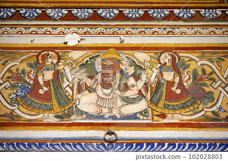 Colourful painting of Lord Ganesha on the inner wall of Dr. Ramnath Podar Haveli Museum, a cultural heritage museum which houses Rajasthani living style, miniature paintings, textiles, jewellery, and Colourful painting of Lord Ganesha on the inner wall of Dr. Ramnath Podar Haveli Museum, a cultural heritage museum which houses Rajasthani living style, miniature paintings, textiles, jewellery, and 102028803