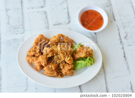 Deep fried chicken tendons with sweet sauce Deep fried chicken tendons with sweet sauce 102028804