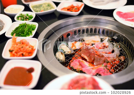 Raw food at grill with ingredients for BBQ 102028926