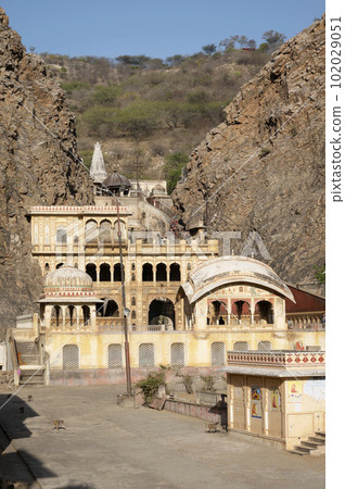 Galtaji Mandir, an ancient Hindu pilgrimage, built within a mountain pass in the Aravalli Hills in early 15th century, Jaipur, Rajasthan, India Galtaji Mandir, an ancient Hindu pilgrimage, built within a mountain pass in the Aravalli Hills in early 15th century, Jaipur, Rajasthan, India 102029051