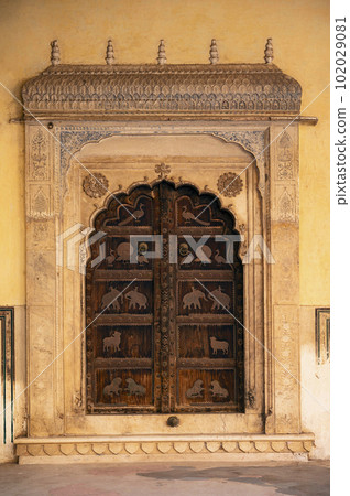 Closed decorative wooden door in Shri Gyan Gopalji Mandir, situated in the premises of Galtaji Mandir, built within a mountain pass in the Aravalli Hills in early 15th century, Jaipur, Rajasthan, Closed decorative wooden door in Shri Gyan Gopalji Mandir, situated in the premises of Galtaji Mandir, built within a mountain pass in the Aravalli Hills in early 15th century, Jaipur, Rajasthan, 102029081