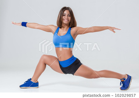 Sporty flexible girl doing stretching exercise Sporty flexible girl doing stretching exercise 102029857