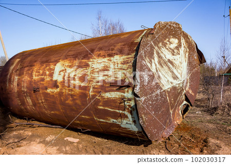Old rusty water tower lying on the ground 102030317