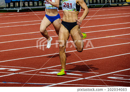 female runner athlete running finish line sprint race track stadium, summer athletics championships female runner athlete running finish line sprint race track stadium, summer athletics championships 102034083