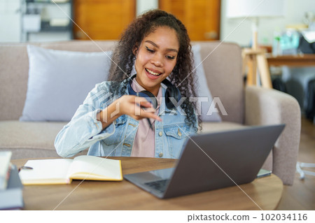 Portrait of African Americans using notebooks, pens to take notes and computers. to study through the Internet, online e learning concept Portrait of African Americans using notebooks, pens to take notes and computers. to study through the Internet, online e learning concept 102034116