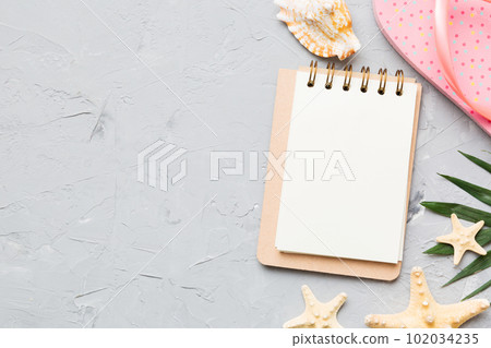 Blank writing book with summer beach accessories on background, copy space. Flat lay with copy space 102034235