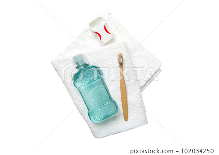 Mouthwash and other oral hygiene products isolated on white background top view with copy space. Flat lay. Dental hygiene. Oral care products and space for text on light background. concept 102034250