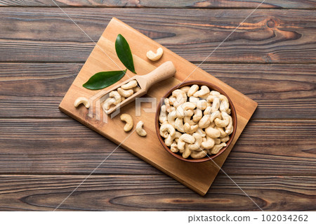 cashew nuts in wooden bowl on table background. top view. Space for text Healthy food 102034262