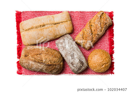 Freshly baked delicious french bread with napkin isolated on white background top view. Healthy white bread loaf 102034407