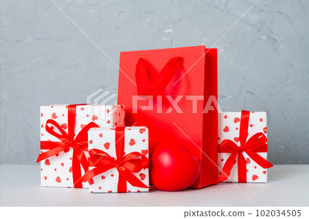 Shopping bag with gift box on colored background perspecrive view. Space for text holiday concept 102034505
