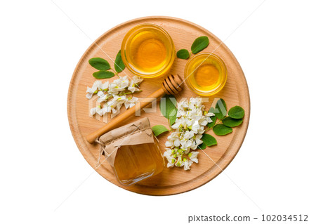honey jar with acacia flowers and leaves isolated on white background. fresh honey top view flat lay honey jar with acacia flowers and leaves isolated on white background. fresh honey top view flat lay 102034512