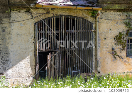 A historic gate of barn in a abandoned building A historic gate of barn in a abandoned building 102039753