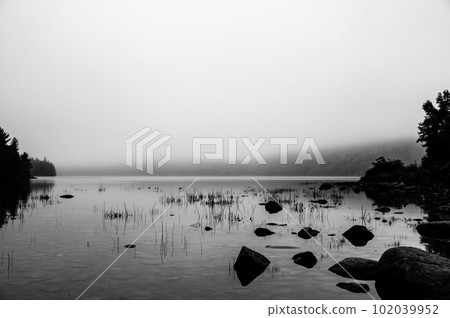Waters edge of Jordan Pond in Acadia National Park, Maine, USA with fog setting into the distance Waters edge of Jordan Pond in Acadia National Park, Maine, USA with fog setting into the distance 102039952