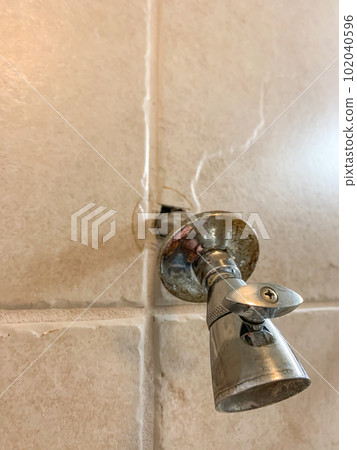 Hole cut into tile with a shower head protruding after installation. Hole cut into tile with a shower head protruding after installation. 102040596