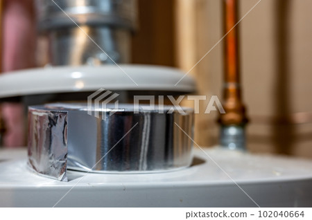 selective focus on the edge of a roll of metallic aluminum foil HVAC duct tape selective focus on the edge of a roll of metallic aluminum foil HVAC duct tape 102040664