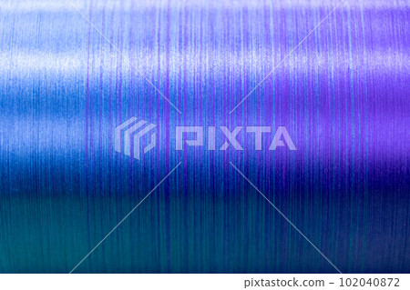Closed up of blue and violet color of thread textured background (Focus at center of picture) Closed up of blue and violet color of thread textured background (Focus at center of picture) 102040872