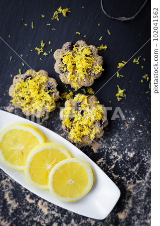 lemon cupcakes on a black background lemon cupcakes on a black background 102041562