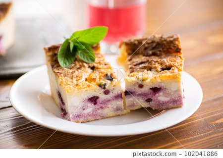cooked cottage cheese casserole with berry filling in a plate 102041886