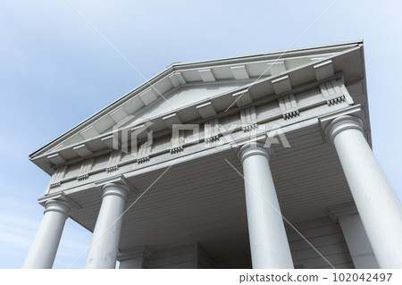White columns and portico under blue sky, classic architecture 102042497