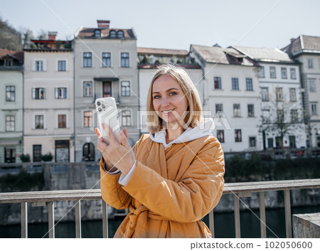 A beautiful young stylish woman walking in the city Spring mood dreaming and waiting a lifestyle concept A beautiful young stylish woman walking in the city Spring mood dreaming and waiting a lifestyle concept 102050600