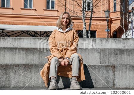A beautiful young stylish woman walking in the city Spring mood dreaming and waiting a lifestyle concept A beautiful young stylish woman walking in the city Spring mood dreaming and waiting a lifestyle concept 102050601