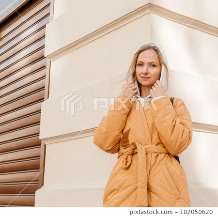 A beautiful young stylish woman walking in the city Spring mood dreaming and waiting a lifestyle concept A beautiful young stylish woman walking in the city Spring mood dreaming and waiting a lifestyle concept 102050620