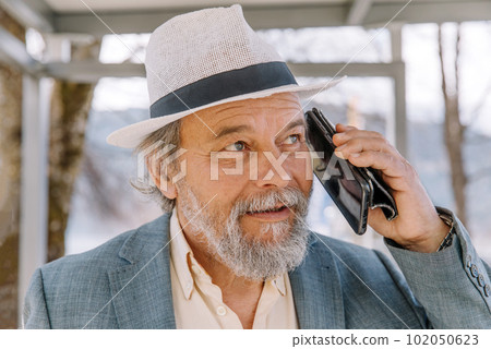Portrait of a confident, handsome, mature man, pensioner, grandfather in the small town Portrait of a confident, handsome, mature man, pensioner, grandfather in the small town 102050623