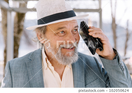 Portrait of a confident, handsome, mature man, pensioner, grandfather in the small town Portrait of a confident, handsome, mature man, pensioner, grandfather in the small town 102050624