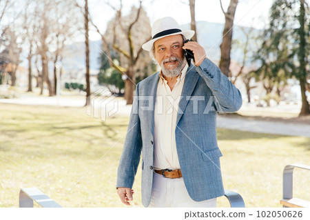 Portrait of a confident, handsome, mature man, pensioner, grandfather in the small town Portrait of a confident, handsome, mature man, pensioner, grandfather in the small town 102050626