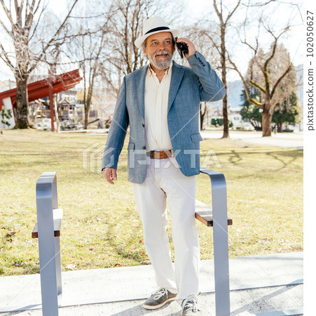 Portrait of a confident, handsome, mature man, pensioner, grandfather in the small town Portrait of a confident, handsome, mature man, pensioner, grandfather in the small town 102050627