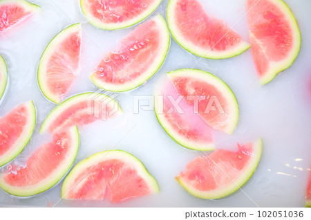 Turbid soapy water in bath with slices of watermelon. top view in full frame. The largest berry. spa with milk in the bath for rejuvenation.. Turbid soapy water in bath with slices of watermelon. top view in full frame. The largest berry. spa with milk in the bath for rejuvenation.. 102051036