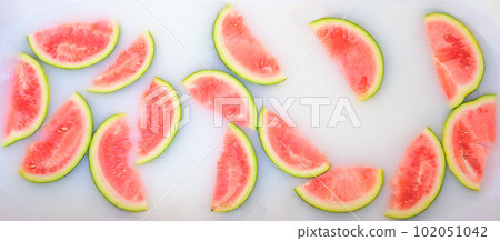 Turbid soapy water in bath with slices of watermelon. top view in full frame. The largest berry. spa with milk in the bath for rejuvenation.. Turbid soapy water in bath with slices of watermelon. top view in full frame. The largest berry. spa with milk in the bath for rejuvenation.. 102051042