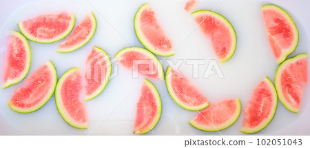 Turbid soapy water in bath with slices of watermelon. top view in full frame. The largest berry. spa with milk in the bath for rejuvenation.. Turbid soapy water in bath with slices of watermelon. top view in full frame. The largest berry. spa with milk in the bath for rejuvenation.. 102051043