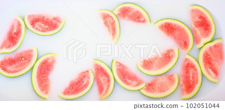 Turbid soapy water in bath with slices of watermelon. top view in full frame. The largest berry. spa with milk in the bath for rejuvenation.. 102051044