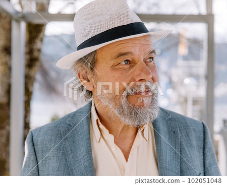 Portrait of a confident, handsome, mature man, pensioner, grandfather in the small town Portrait of a confident, handsome, mature man, pensioner, grandfather in the small town 102051048