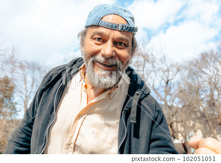 Portrait of a confident, handsome, mature man, pensioner, grandfather in the small town Portrait of a confident, handsome, mature man, pensioner, grandfather in the small town 102051051