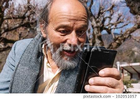 Portrait of a confident, handsome, mature man, pensioner, grandfather in the small town Portrait of a confident, handsome, mature man, pensioner, grandfather in the small town 102051057
