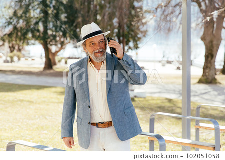 Portrait of a confident, handsome, mature man, pensioner, grandfather in the small town Portrait of a confident, handsome, mature man, pensioner, grandfather in the small town 102051058