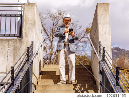 Portrait of a confident, handsome, mature man, pensioner, grandfather in the small town 102051465