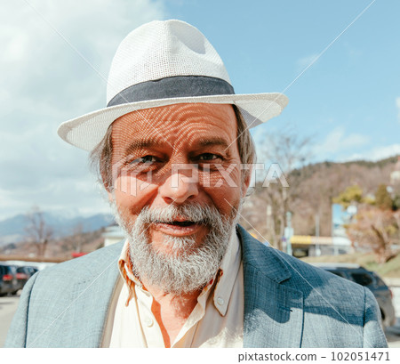 Portrait of a confident, handsome, mature man, pensioner, grandfather in the small town 102051471