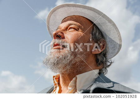Portrait of a confident, handsome, mature man, pensioner, grandfather in the small town Portrait of a confident, handsome, mature man, pensioner, grandfather in the small town 102051928