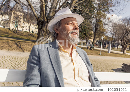 Portrait of a confident, handsome, mature man, pensioner, grandfather in the small town 102051931