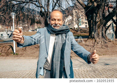 Portrait of a confident, handsome, mature man, pensioner, grandfather in the small town 102051935
