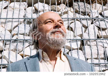 Portrait of a confident, handsome, mature man, pensioner, grandfather in the small town Portrait of a confident, handsome, mature man, pensioner, grandfather in the small town 102051942